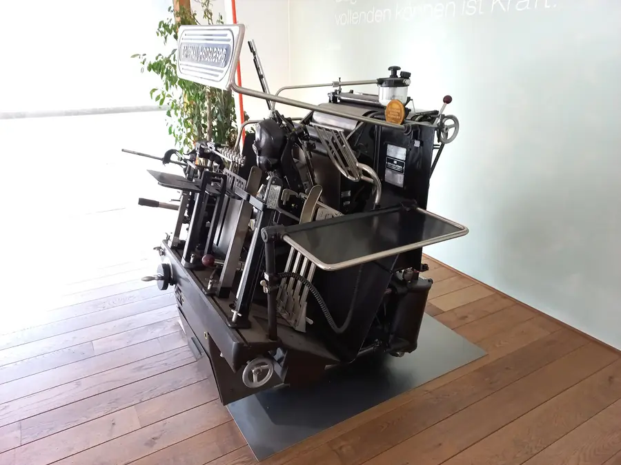Restored Heidelberg platen printing press on a showroom floor